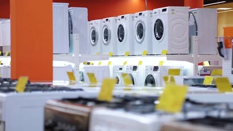 Selling washing machines in home appliances store Stock Footage