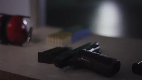 Semi Automatic Pistol Lying on Range Counter, Indoor Firing Booth, Close Up Video stock 341321293