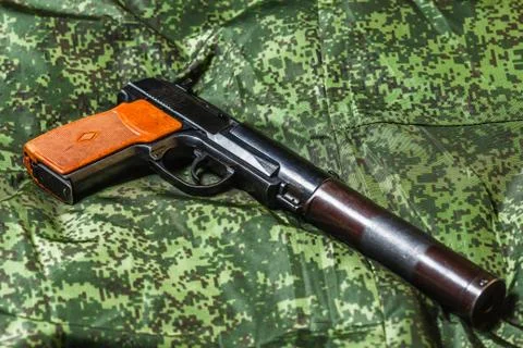 Semi-automatic silenced pistol on pixel camouflage background 스톡 사진