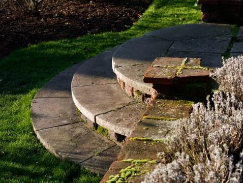 Semi circle round stone steps in a garden Foto stock