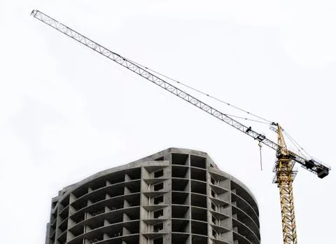Semi-circular building under construction with a crane on the background of t Stock Photos
