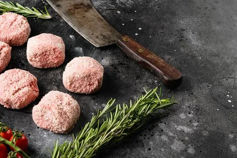 Semi-finished products, raw meatball, on black dark stone table background, w Stock Photos