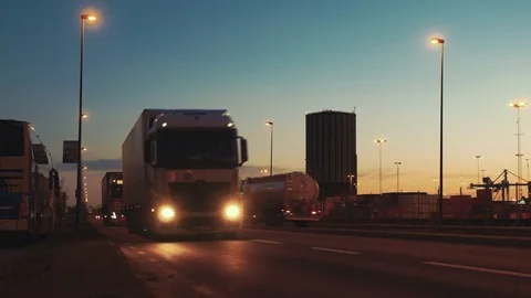 Semi trailer trucks and tanker trucks traffic at dusk. Logistics transportation Stock Footage