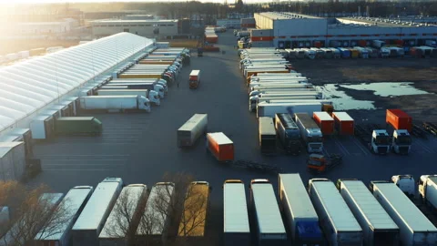 Semi-trailers trucks stand on the parking lot and at warehouse ramps for loading Video stock 156306069