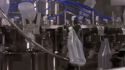 Semi-transparent plastic bottles moving through the production line. Video stock 250479449