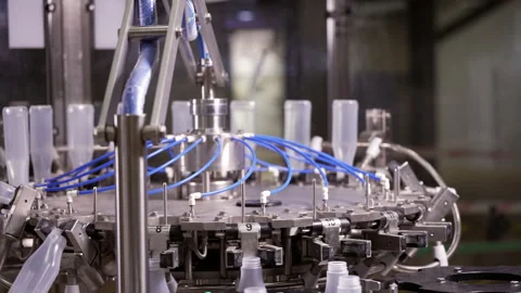 Semi-transparent plastic bottles moving through the production line. Video stock 250480304