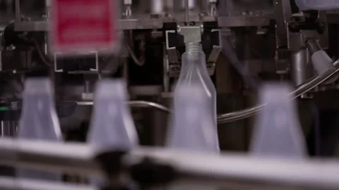Semi-transparent plastic bottles moving through the production line. Video stock 250481465