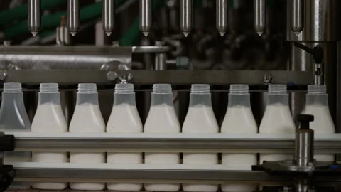 Semi-transparent plastic bottles moving through the production line. Video stock 250482359