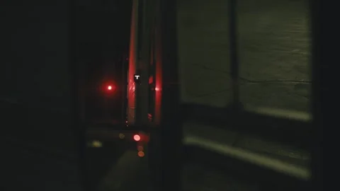 Semi truck backing into warehouse loading dock at night Video stock 346969948