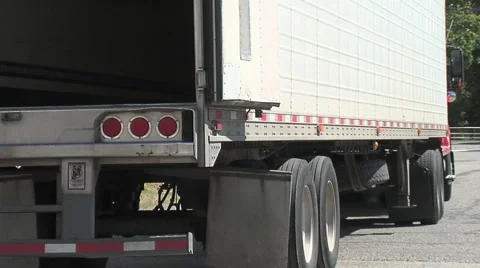 Semi truck backs into loading dock Stock Footage