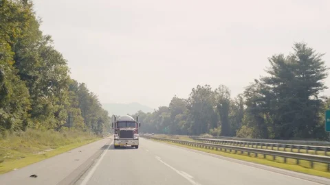 Semi Truck Drives down interstate highway in North Carolina Stock Footage 94738783