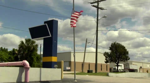 Semi truck drives by while flag flies at half mast Stock Footage 22801980