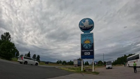 Semi truck passing the Arctic Circle signpost in Juoksenki Lapland Finland Stock-Footage 340960129