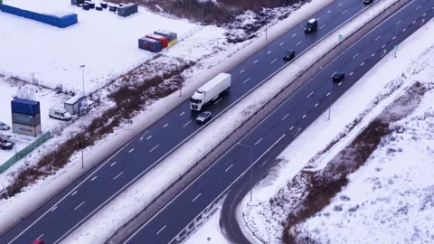 Semi truck transporting cargo in winter season, aerial drone view Video stock 328958475