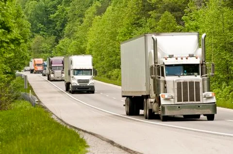 Semi Trucks On The Interstate Stock Photos