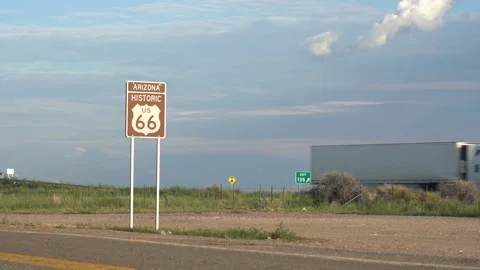Semi trucks passing on an interstate highway next to old Route 66 Stock Footage 159629602