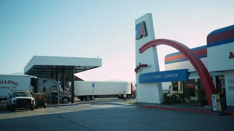 Semi-Trucks stop on journey across the CA desert at rest area outside Coachella. Stock Footage