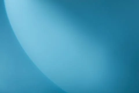 A semicircle of lights hits a light blue background Stock Photos