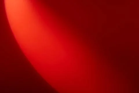 A semicircle of lights hits a red background Stock Photos