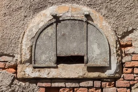 Semicircular old window on an old brick wall Stock Photos