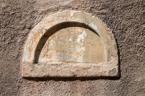 Semicircular walled up small old window Stock Photos
