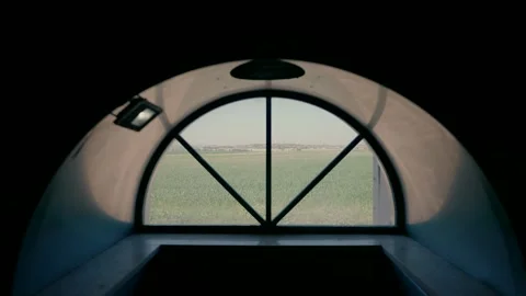 Semicircular window through the steps you see a green field. Stock Footage 269491196