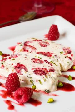 Semifreddo with raspberry and pistachios Stock Photos
