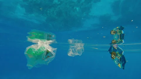 Semitransparent bag filled with garbage with other plastic trash drifting under Stock Footage 339967946