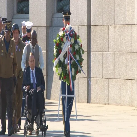 Senator Bob Dole is pushed during WWII ceremony in Washington, D.C.  Stock Footage 69661533