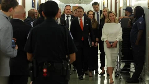 Senators and staff walk through a Senate office building corridor Stock Footage 345284022
