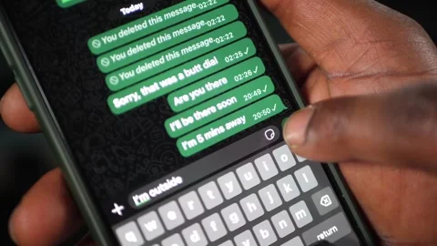 Send a message on a smartphone with both hands Stockbeeldmateriaal 307595937