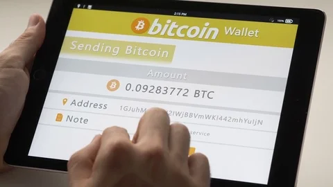 Sending Bitcoin With a Tablet Wallet App Stock Footage 80426660