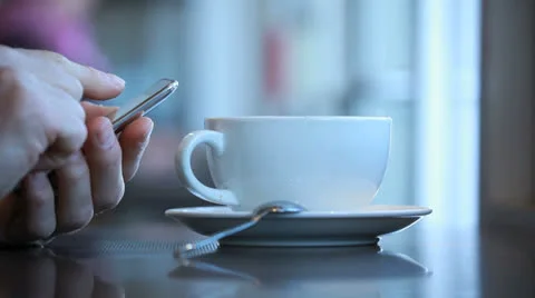 Sending email or text at a coffee shop Stock Footage 24527800