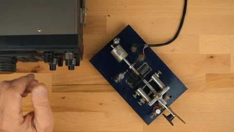 Sending a message via Morse code on a shortwave ham radio Video stock 130030154