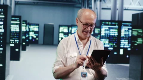 Senescent employee optimizes data center Stock Footage 249772694