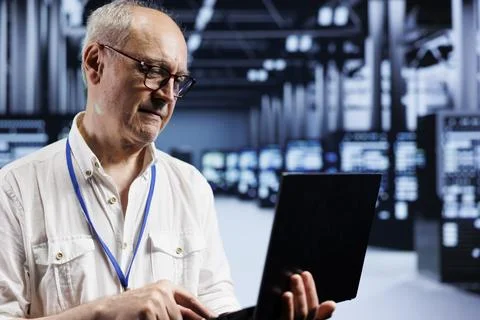 Senescent system admin inspects servers Stock Photos