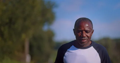 Senior african-american man running outdoors on park Stock Footage