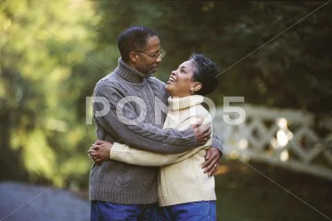 Senior African couple hugging outdoors Stock Photos