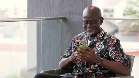 Senior African Man Using Smartphone for Family Video Call Видео 346007739