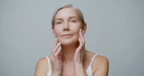 A senior age model without makeup posing looking at the camera Stock Footage 168054374