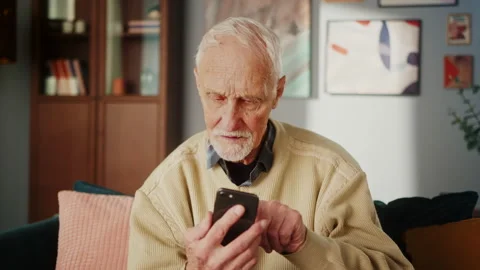 Senior aged elderly man using phone, chatting and talking speaking family or Video stock 233158988
