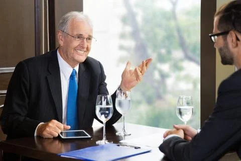 Senior and Young Businessmen Talking Stock Photos