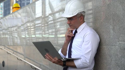 Senior architect checking list construction site with laptop computer outdoor Stock Footage 162280720