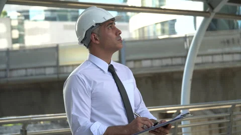Senior architect checking list construction site with clipboard outdoors . ol Stock Footage 162281207