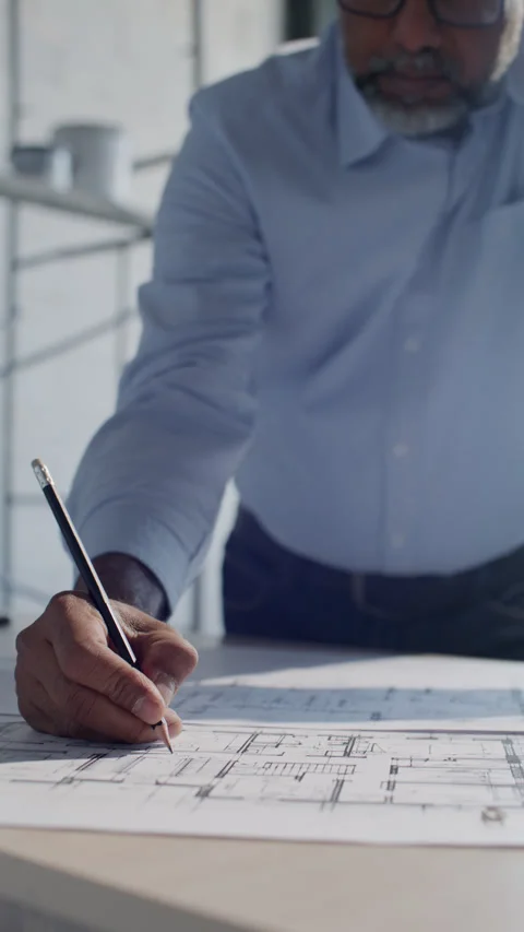 Senior Architect Drafting Building Plans on Paper at Construction Plan Stock Footage 332249666