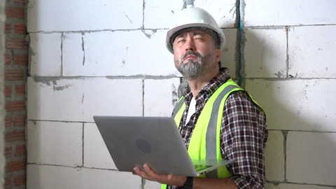 Senior architect or civil engineer using laptop computer inspection at cons.. Stock Footage 262154798