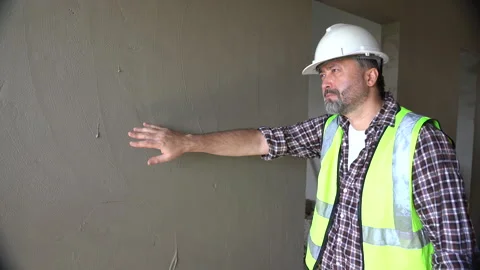 Senior architect or civil engineer inspection after plaster wall at constru.. Stock Footage 262155211