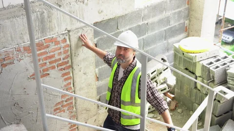 Senior architect or civil engineer inspection or checking Stairs at constru.. Stock Footage 262155989
