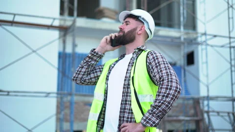 Senior architect or civil engineer talking to phone pointing finger to insp.. Stock Footage 262159591