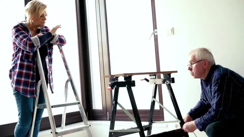 Senior arguing while man assembling furniture at their new home Видео 95140799
